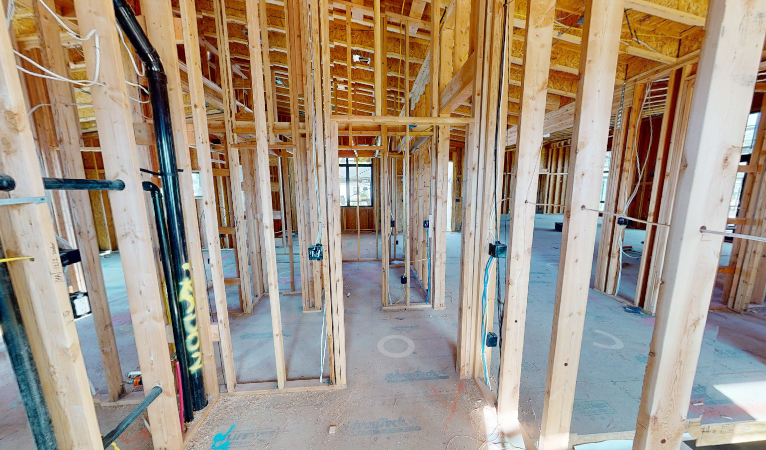 Construction progress — framing and rough-ins visible before drywall